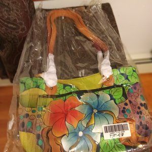 NEW IN ORIGINAL PACKING. ANUSCHA HANDPAINTED LEATHER BAG 13 INCH BY 8.5 INCH.